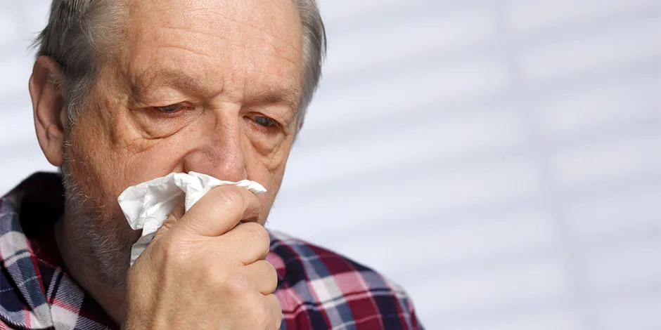 Disminuye en casa las alergias a los perros con uno hipoalergénico. Anciano con pañuelo en su rostro